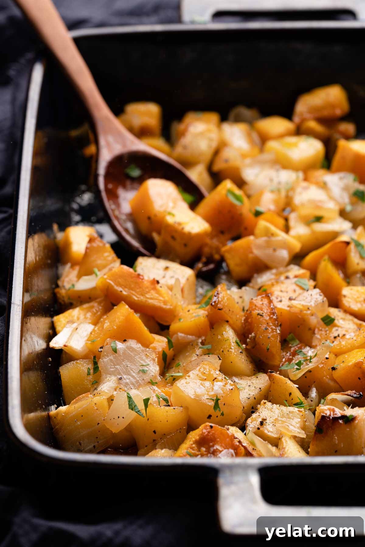 Maple-Glazed Roasted Squash and Apples for Fall Side Dish 2 maple glazed squash and apples in casserole dish with wooden spoon