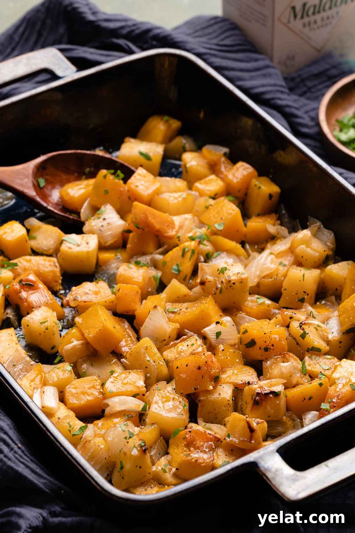 Maple-Glazed Roasted Squash and Apples for Fall Side Dish 13 squash and apples in blue casserole dish with herbs on the side