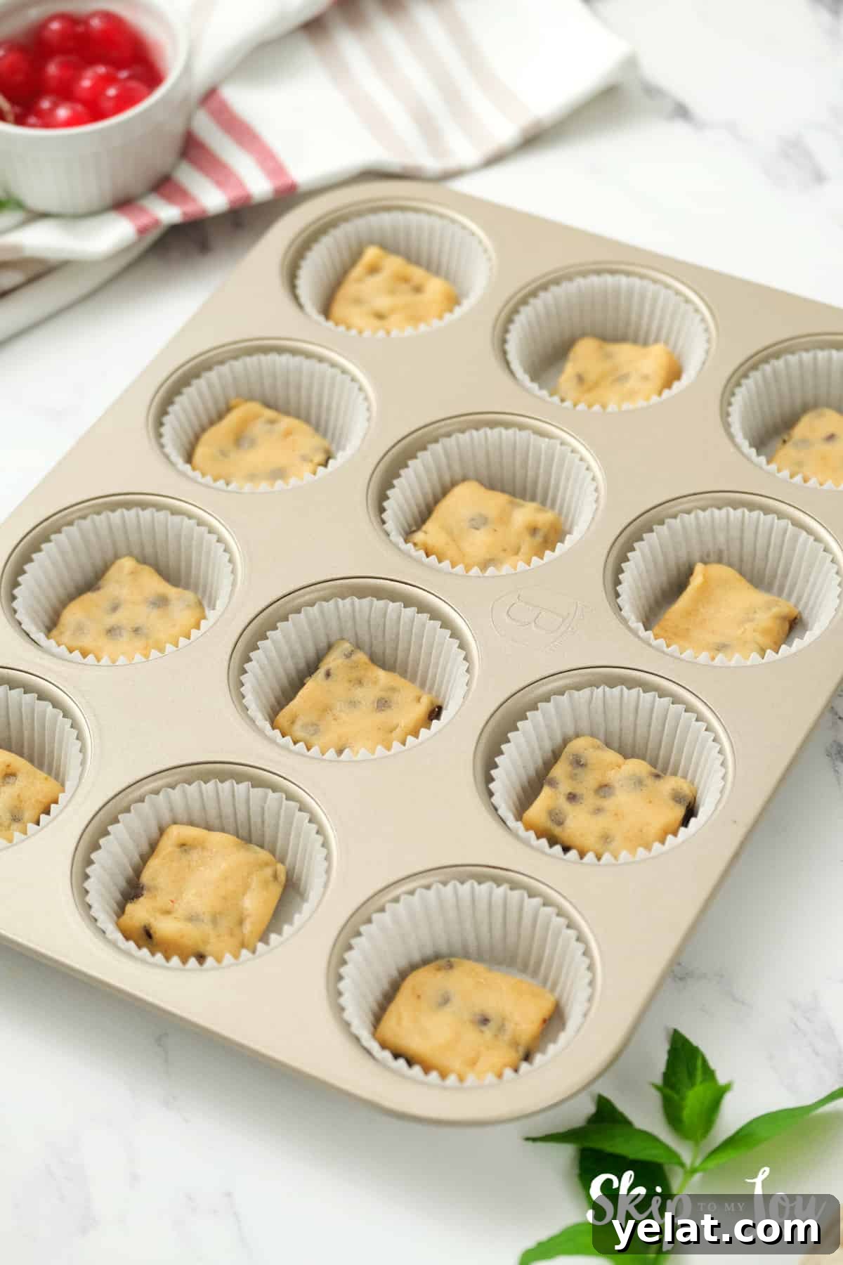 place cookie dough into lined muffin tin