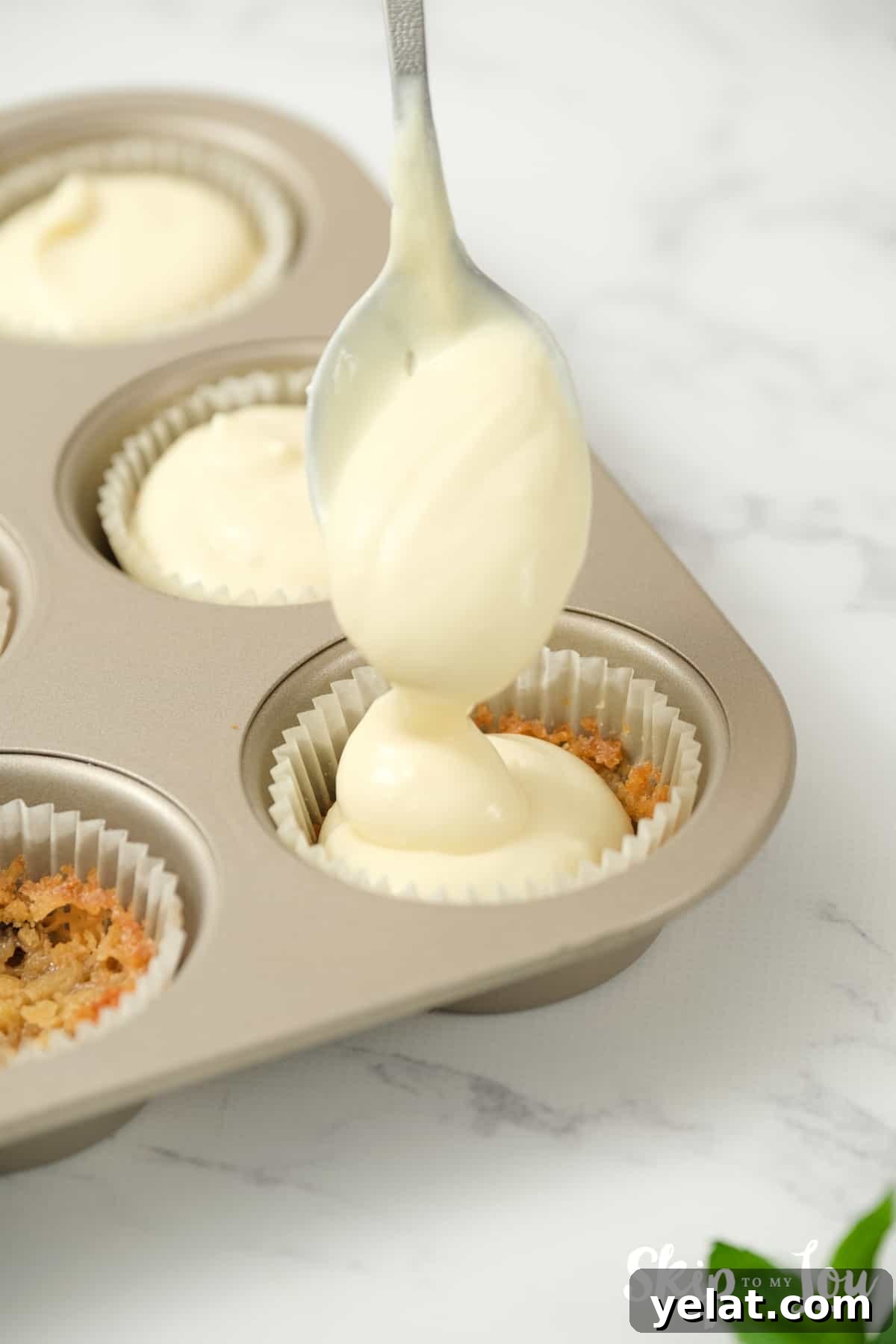 spoon cheesecake batter on top of cookie
