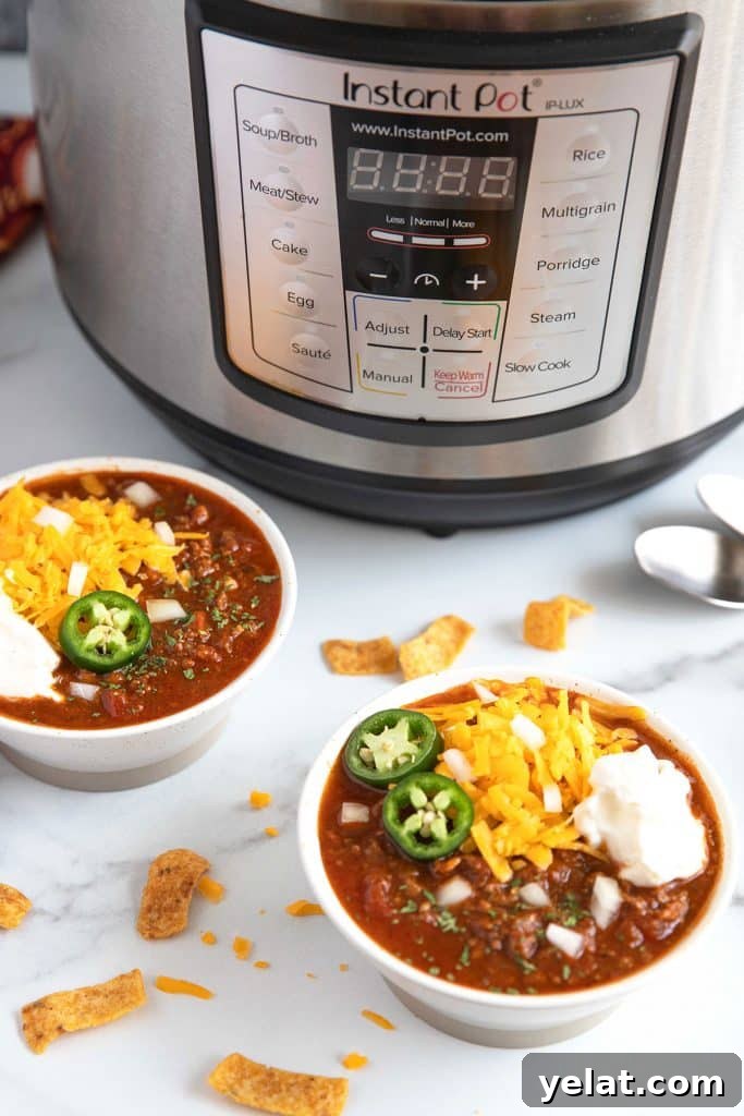 Bowls of chili sitting next to an Instant Pot pressure cooker.