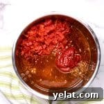 diced tomatoes, tomato paste, beer and beef broth over the ground beef