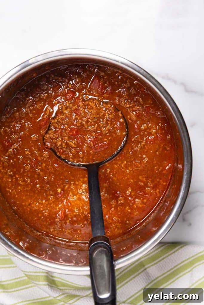 scooping texas chili from an instant pot