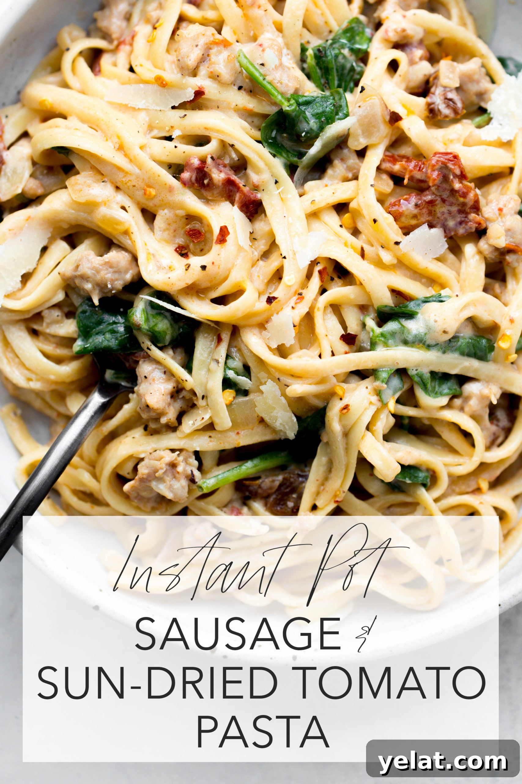 instant pot sausage sun-dried tomato pasta overhead in a gray bowl with title text overlay