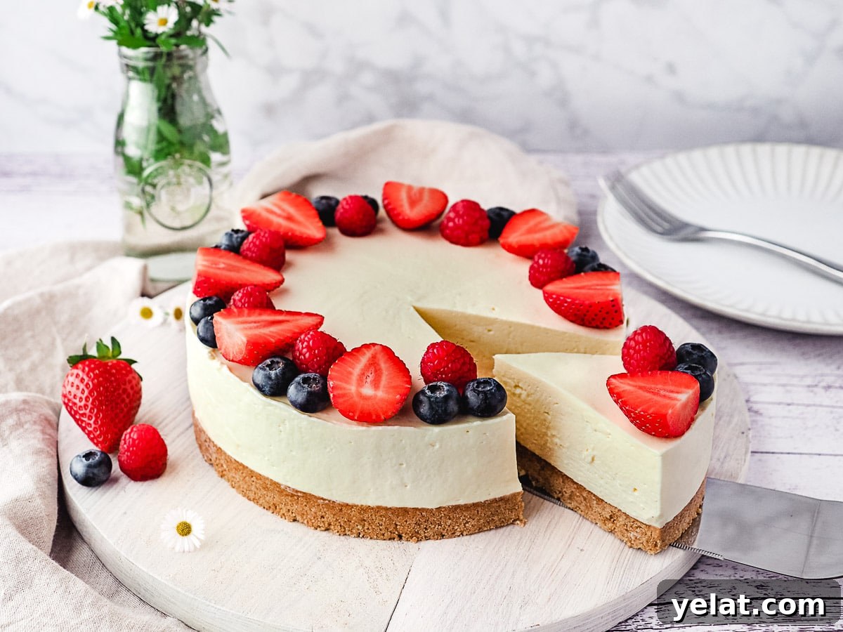 Philadelphia No-Bake Cheesecake Recipe — Creamy, Refrigerator Cheesecake 10 Slicing cheesecake decorated with fresh berries.