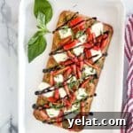 Caprese flatbread on a serving tray with basil.