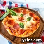 Fire grilled pizza on a wooden serving tray with basil.