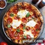 Pizza crust with salad, spices, and tomatoes.