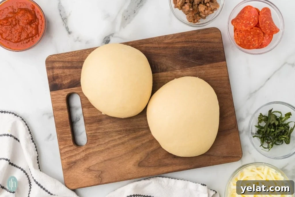 Two rounds of dough with pizza toppings on the side.