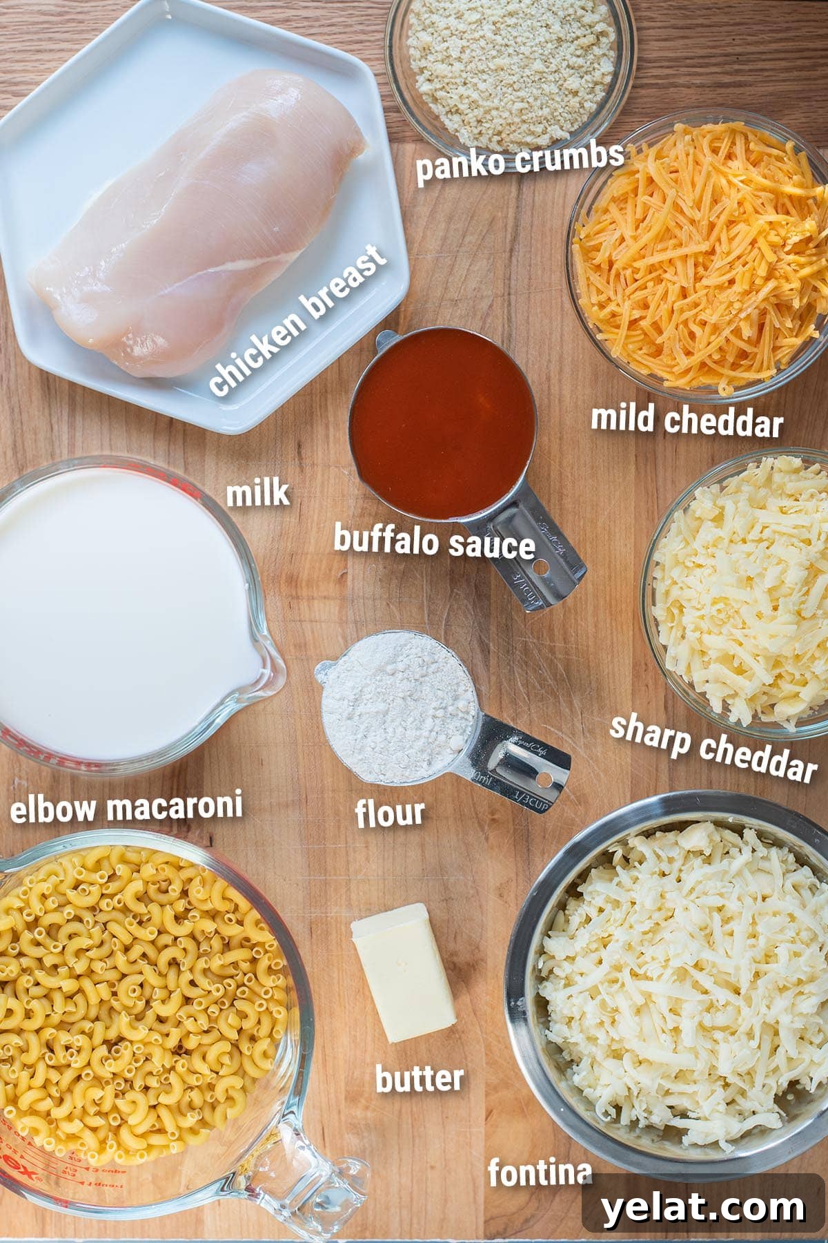 Skillet Buffalo Chicken Macaroni and Cheese Recipe 3 Raw/uncooked buffalo chicken mac and cheese ingredients laid out on a cutting board.