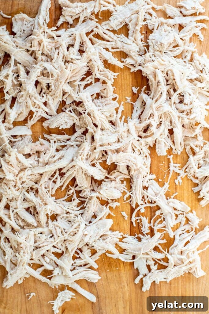 Skillet Buffalo Chicken Macaroni and Cheese Recipe 6 Finely shredded chicken laid out on a cutting board.