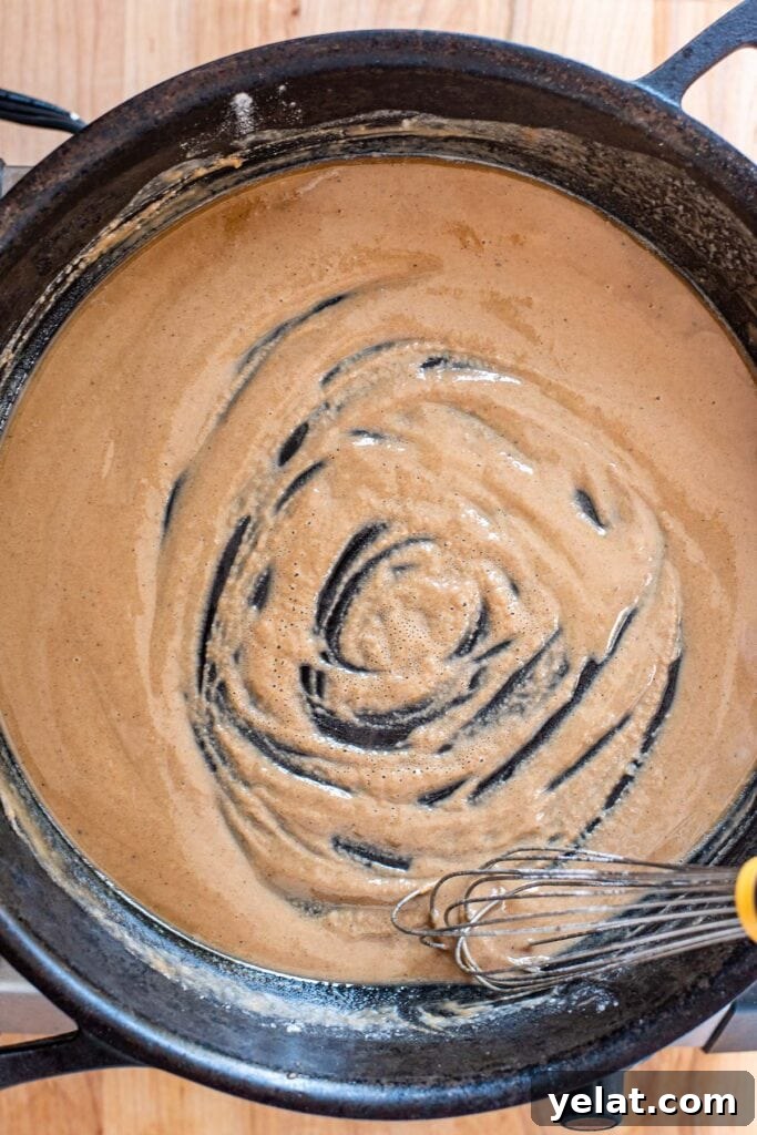 Skillet Buffalo Chicken Macaroni and Cheese Recipe 10 Stirring a golden roux with a whisk in a cast iron skillet.