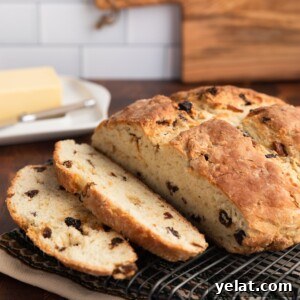 Classic Irish-American Soda Bread Recipe for Homemade Loaves 9 sliced loaf of Irish-American soda bread on a wire baking rack
