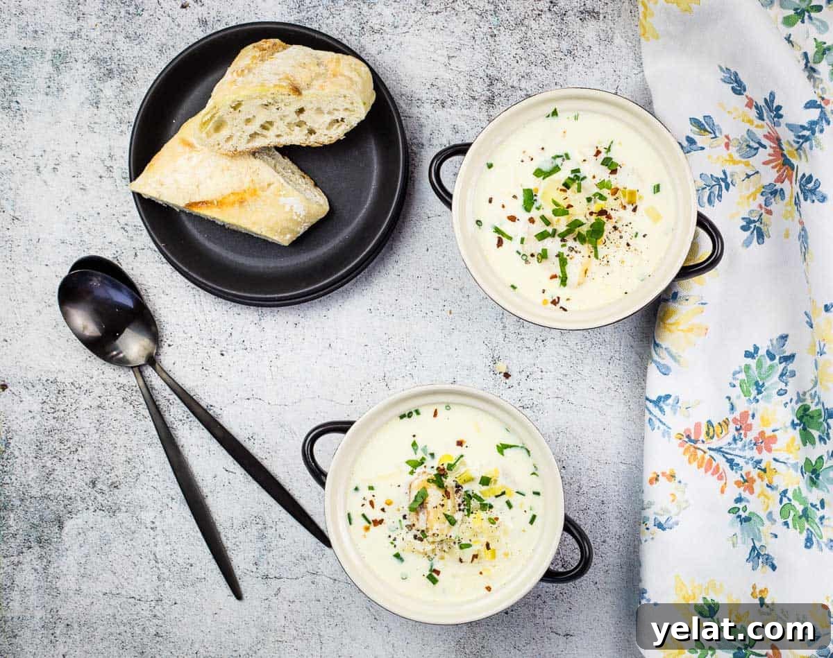 Cullen Skink in two bowls with crusty bread in the background.