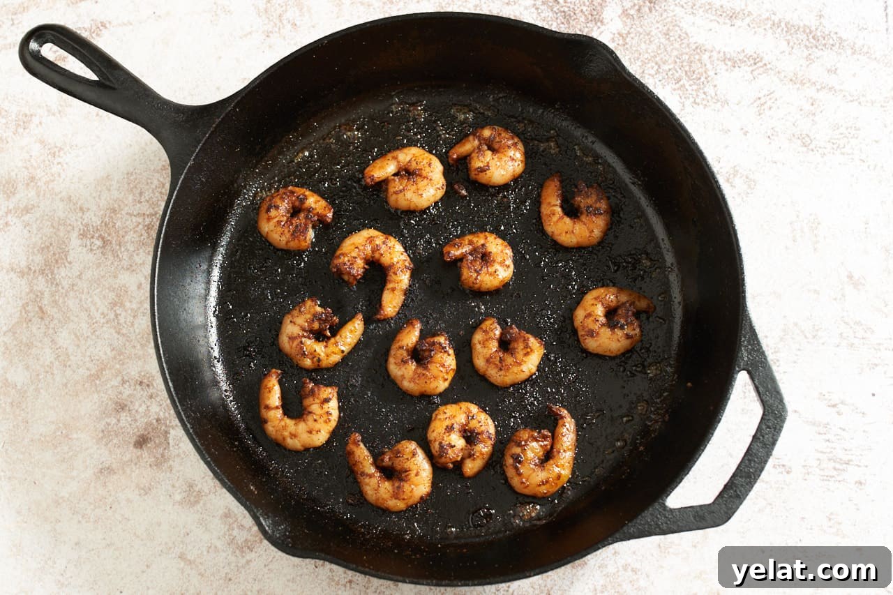 Cooked shrimp in a cast iron pan.