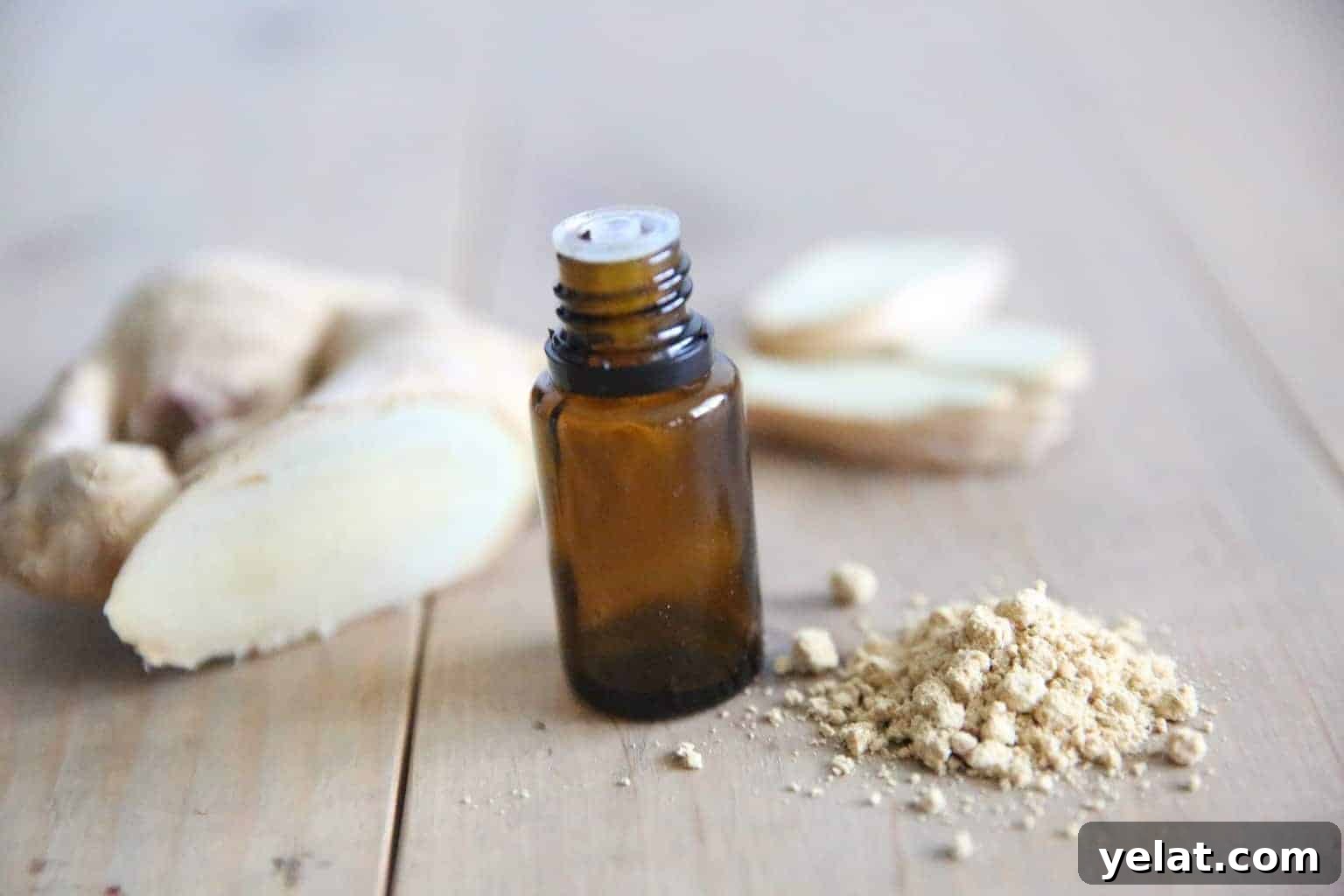 essential oil bottle with ginger on wooden table