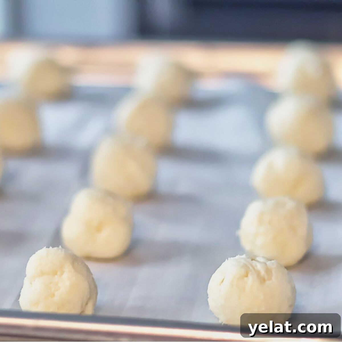 Irresistible Gluten-Free Ricotta Cookie Recipe 9 dough rolled into balls and on parchment lined baking sheet.