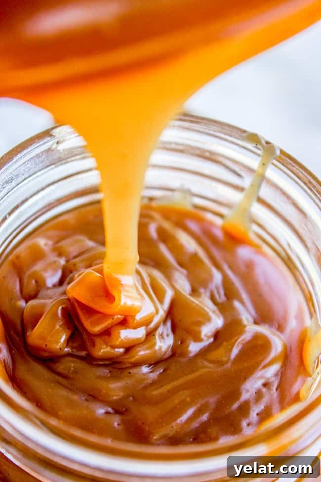 Homemade Caramel Sauce Recipe for Rich, Smooth Results 2 caramel sauce being poured into a mason jar.