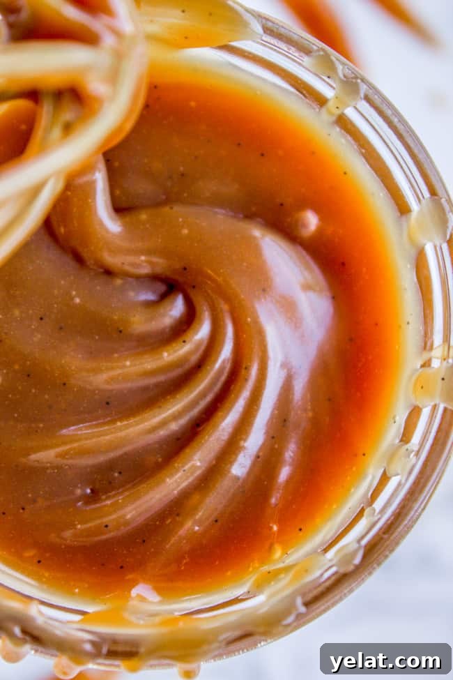 Homemade Caramel Sauce Recipe for Rich, Smooth Results 8 caramel sauce shot from up close in a mason jar.