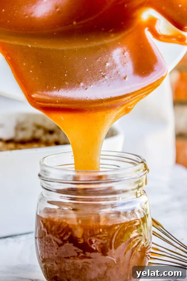Homemade Caramel Sauce Recipe for Rich, Smooth Results 3 caramel sauce being poured into a mason jar.