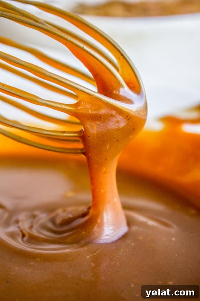Homemade Caramel Sauce Recipe for Rich, Smooth Results 4 thick caramel sauce pouring off a whisk.