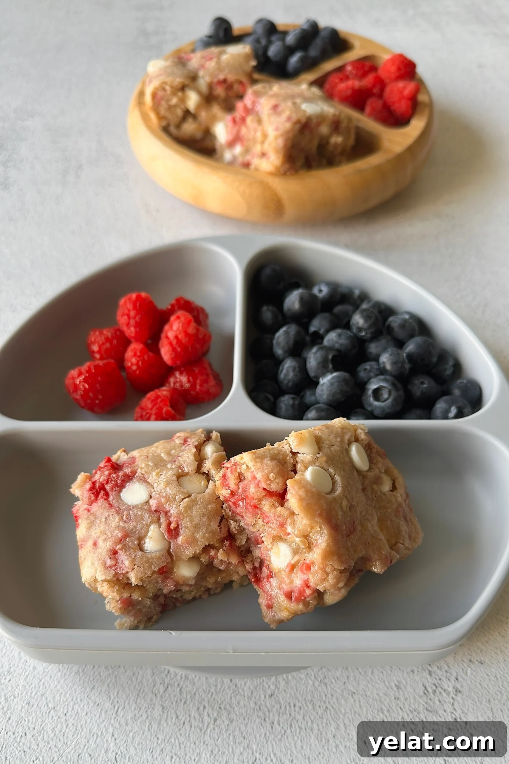 Raspberry White Chocolate Blondies Recipe — Chewy Berry Bars 6 Raspberry white chocolate blondies served with berries.