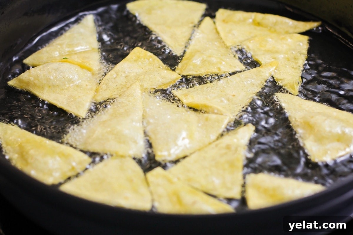 Add a little spice to your breakfast with this authentic chilaquiles recipe - a Mexican classic that's on the table in only 20 minutes! Frying tortillas in a pan of oil.