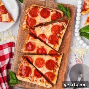How to Make Perfect Calzones on a Blackstone Griddle 11 Thin-crust pepperoni pizza on a wooden serving board with fresh basil. Perfect for easy homemade pizza recipes.