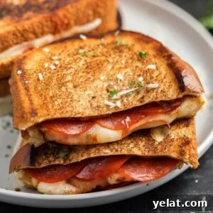 How to Make Perfect Calzones on a Blackstone Griddle 12 crispy grilled cheese sandwich with pepperoni and herbs, close-up on plate