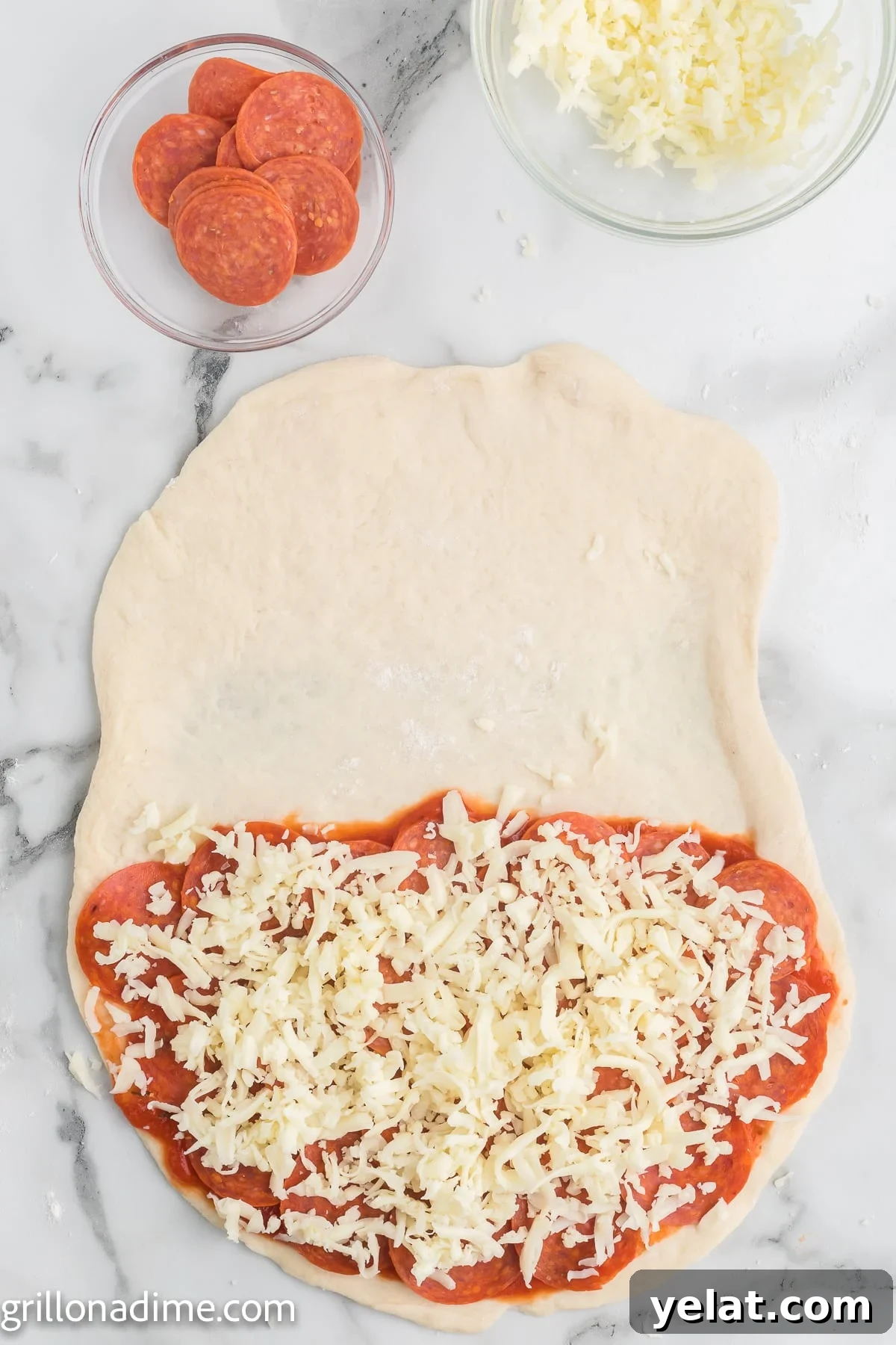 How to Make Perfect Calzones on a Blackstone Griddle 5 Pizza dough topped with pizza sauce, shredded cheese, and pepperoni
