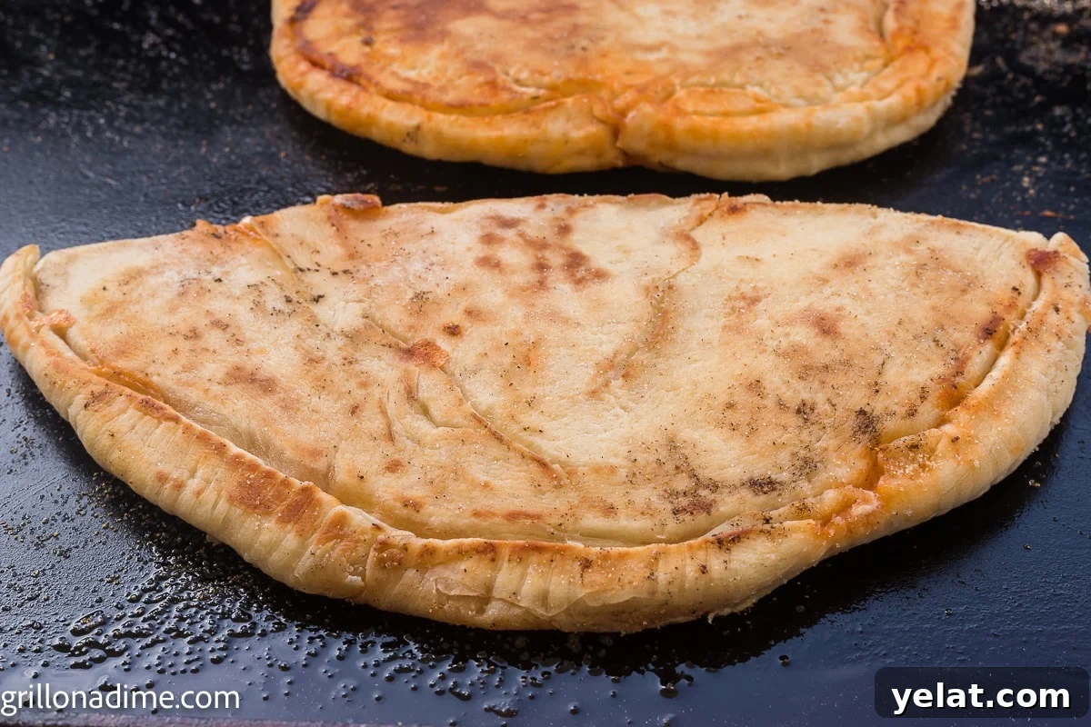 How to Make Perfect Calzones on a Blackstone Griddle 8 cooked calzone on the griddle