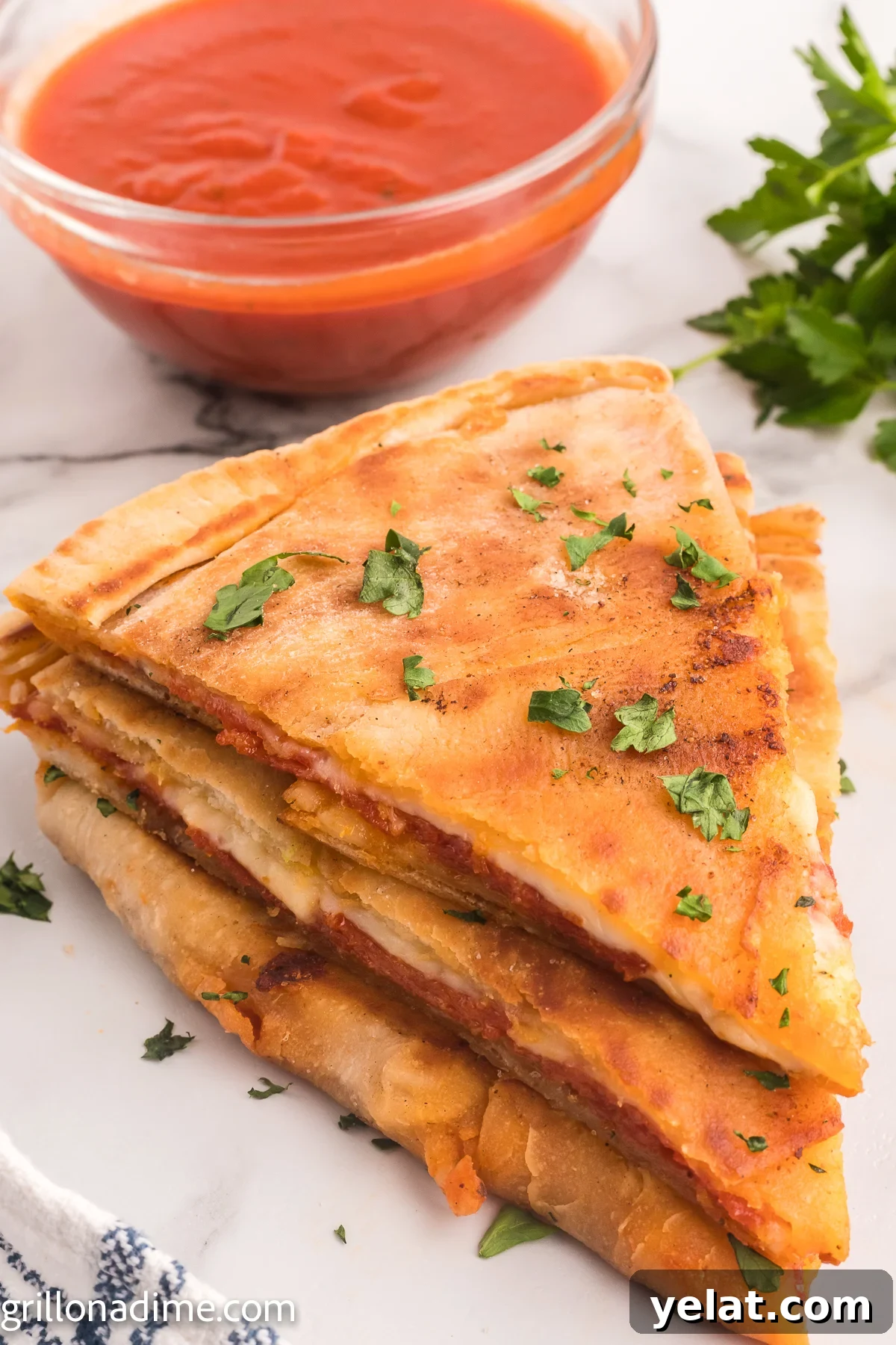 How to Make Perfect Calzones on a Blackstone Griddle 9 Blackstone Pizza Calzone stacked with a side of sauce