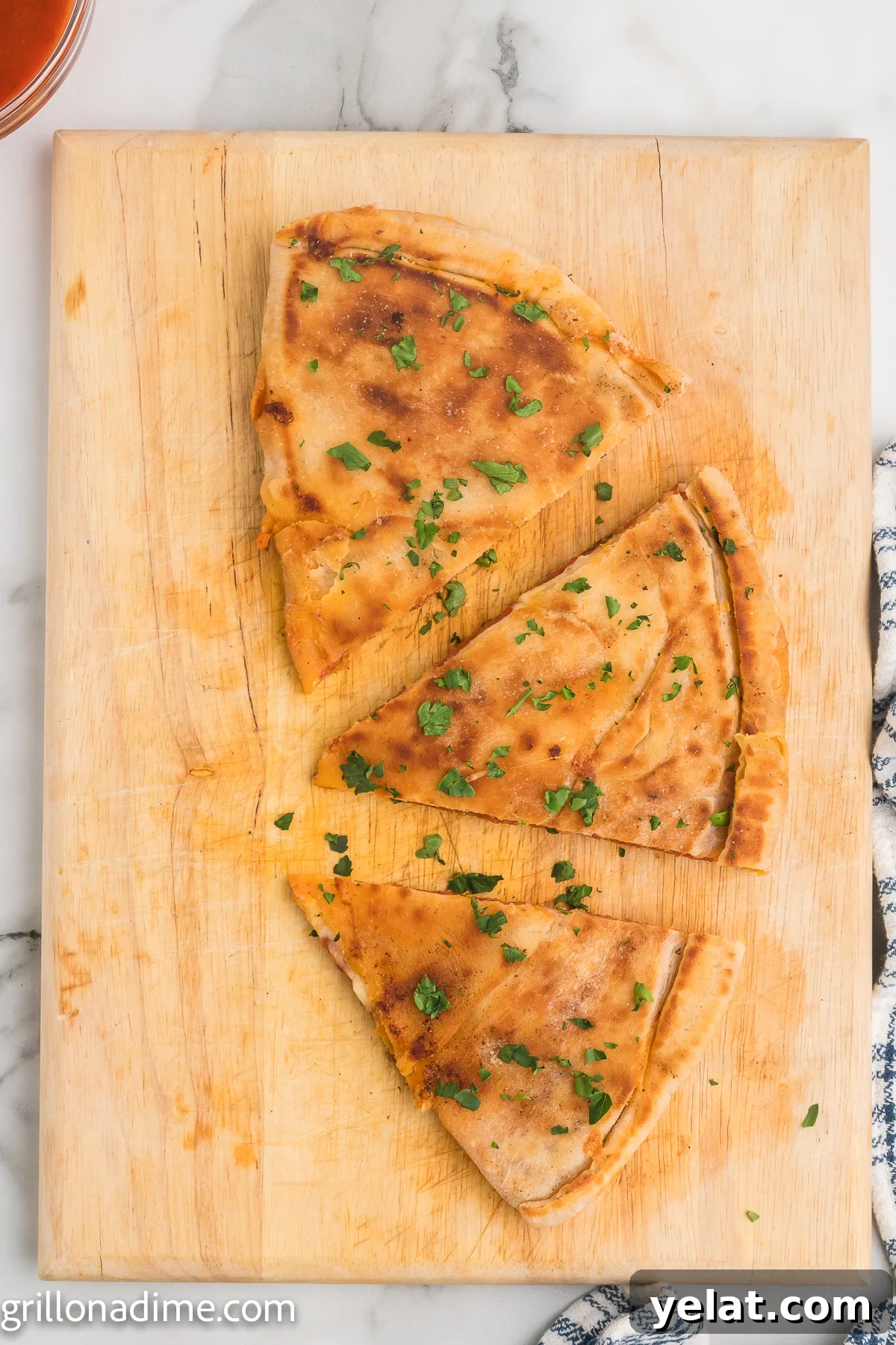 How to Make Perfect Calzones on a Blackstone Griddle 10 Blackstone Pizza Calzone on a cutting board sliced