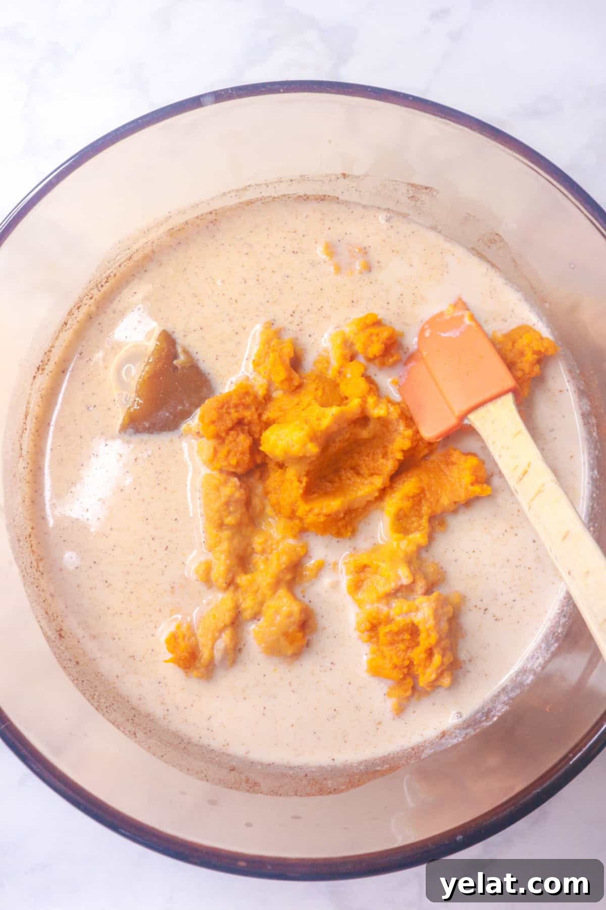 Added pumpkin puree to rice pudding mixture in a small pot