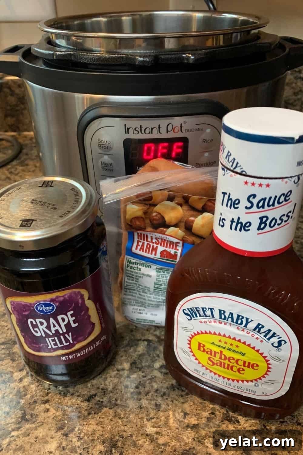 a jar of grape jelly, a bottle of bbq sauce, and a package of cocktail sausages in front of an Instant Pot