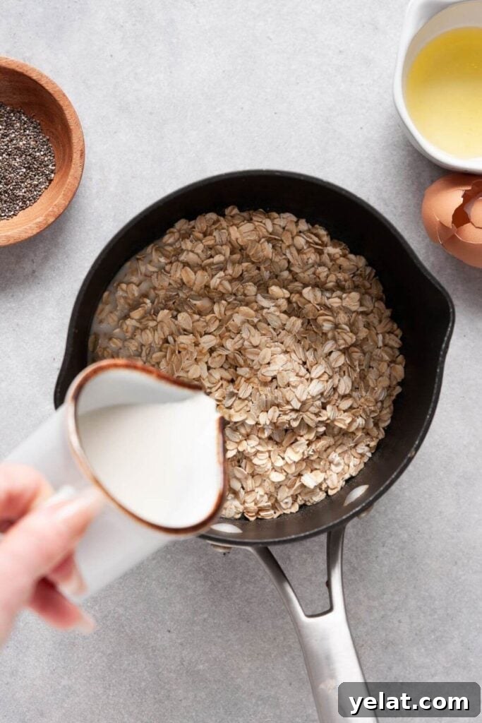 Protein Oatmeal with Egg Whites for Muscle Fuel and Satiety 4 adding milk to stovetop protein oatmeal