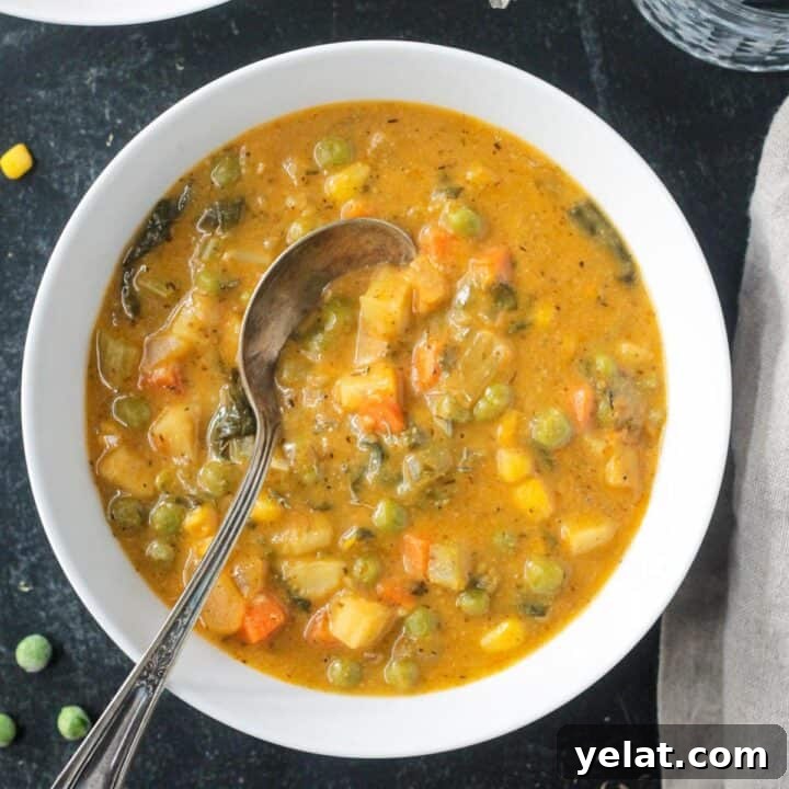 Comforting Vegan Soup Recipes to Warm Your Weeknight Meals 6 Metal spoon in a bowl of creamy vegetable soup.