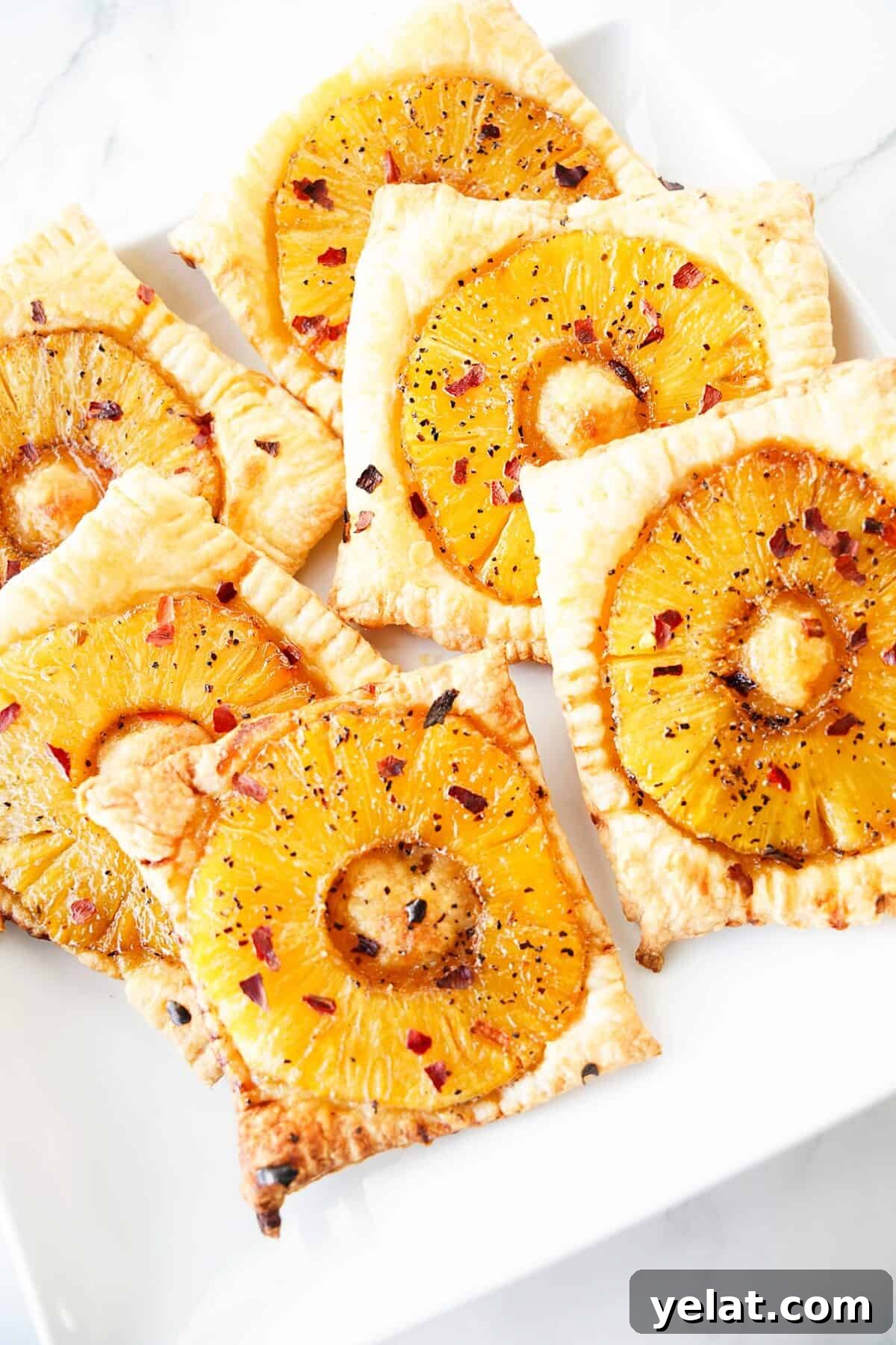 Spicy Pineapple Tart Recipe: Sweet and Tangy Baked Cookies 2 close up vertical shot of spicy pineapple tarts on white plate