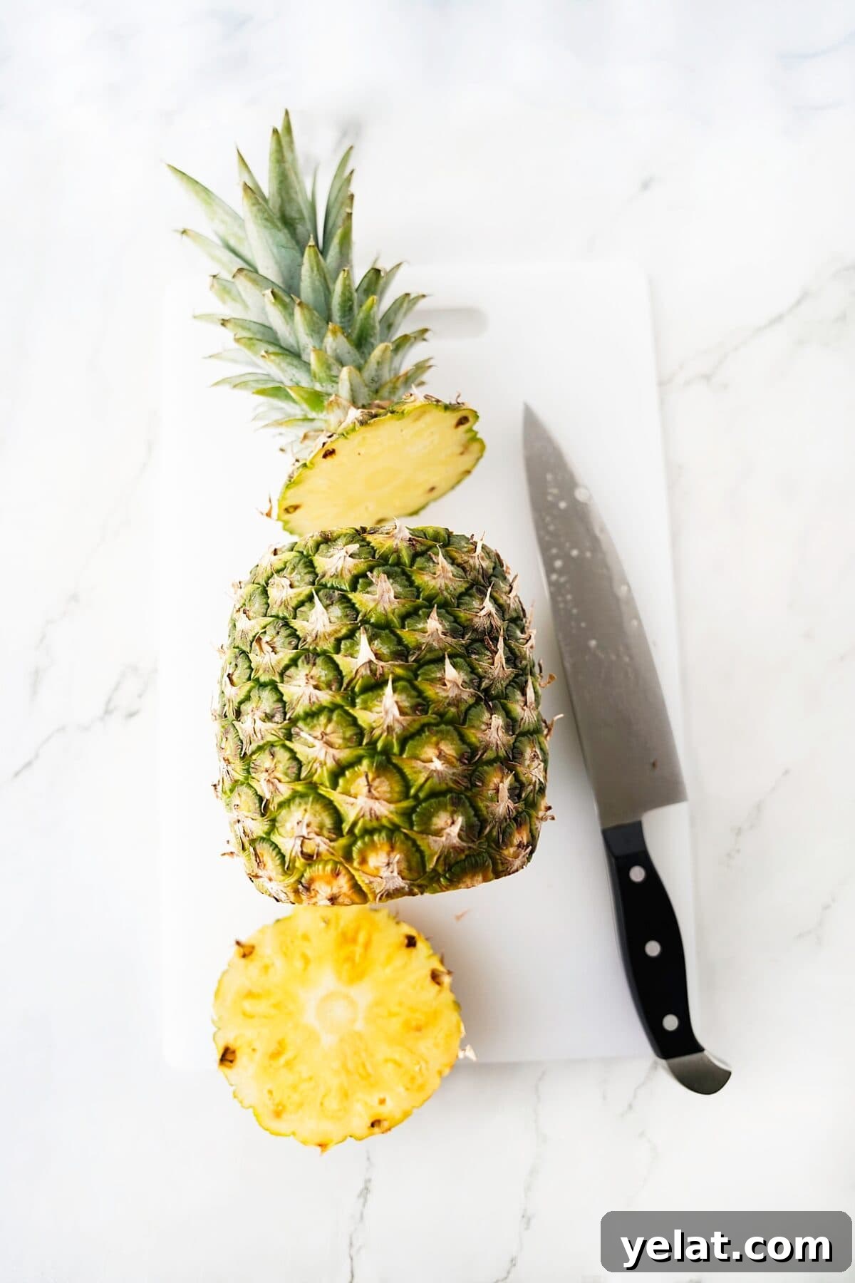 Spicy Pineapple Tart Recipe: Sweet and Tangy Baked Cookies 5 overhead shot of pineapple with top and bottom cut off with knife on cutting board