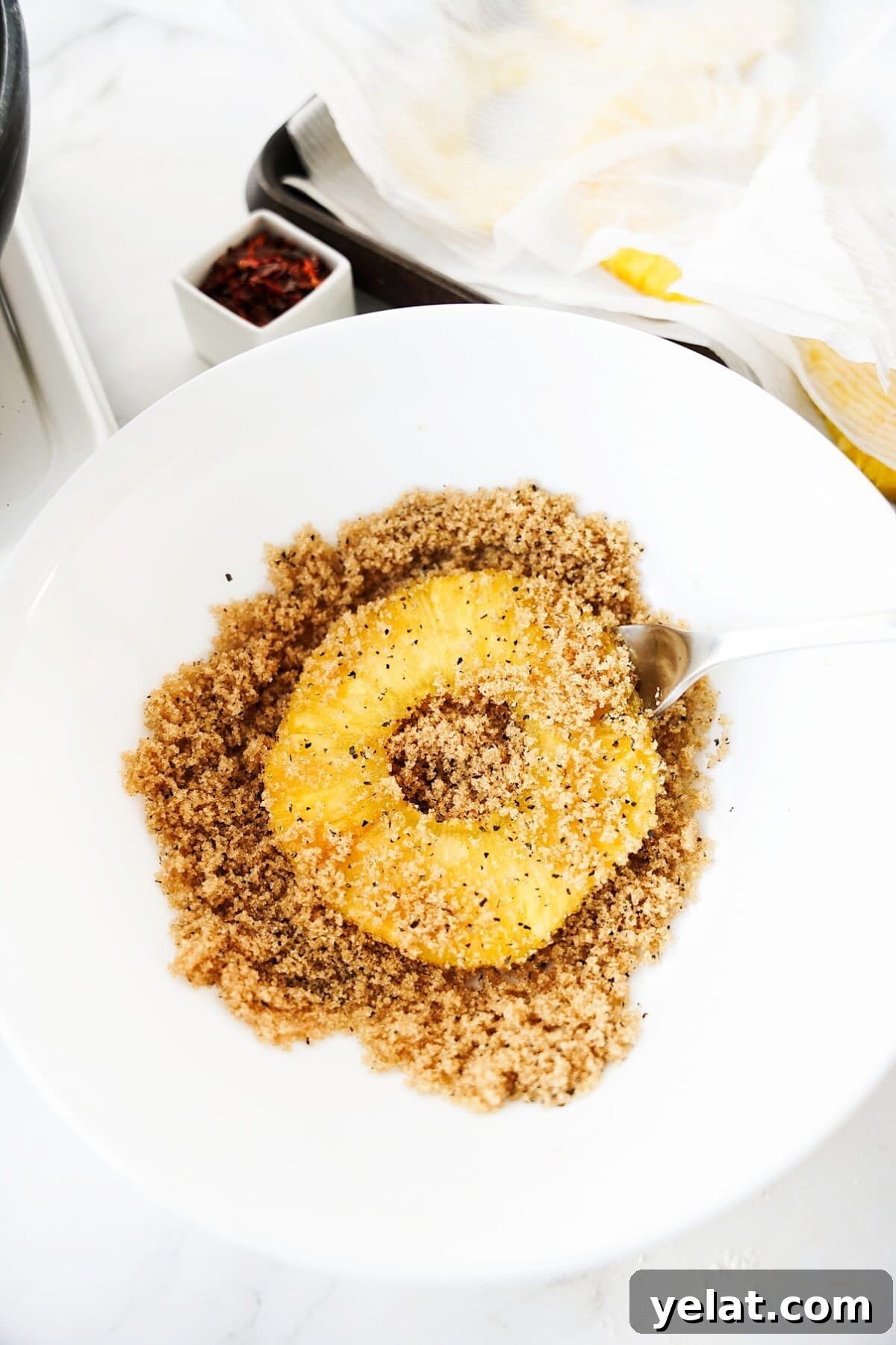 Spicy Pineapple Tart Recipe: Sweet and Tangy Baked Cookies 7 slice of pineapple in bowl with brown sugar, pepper and salt