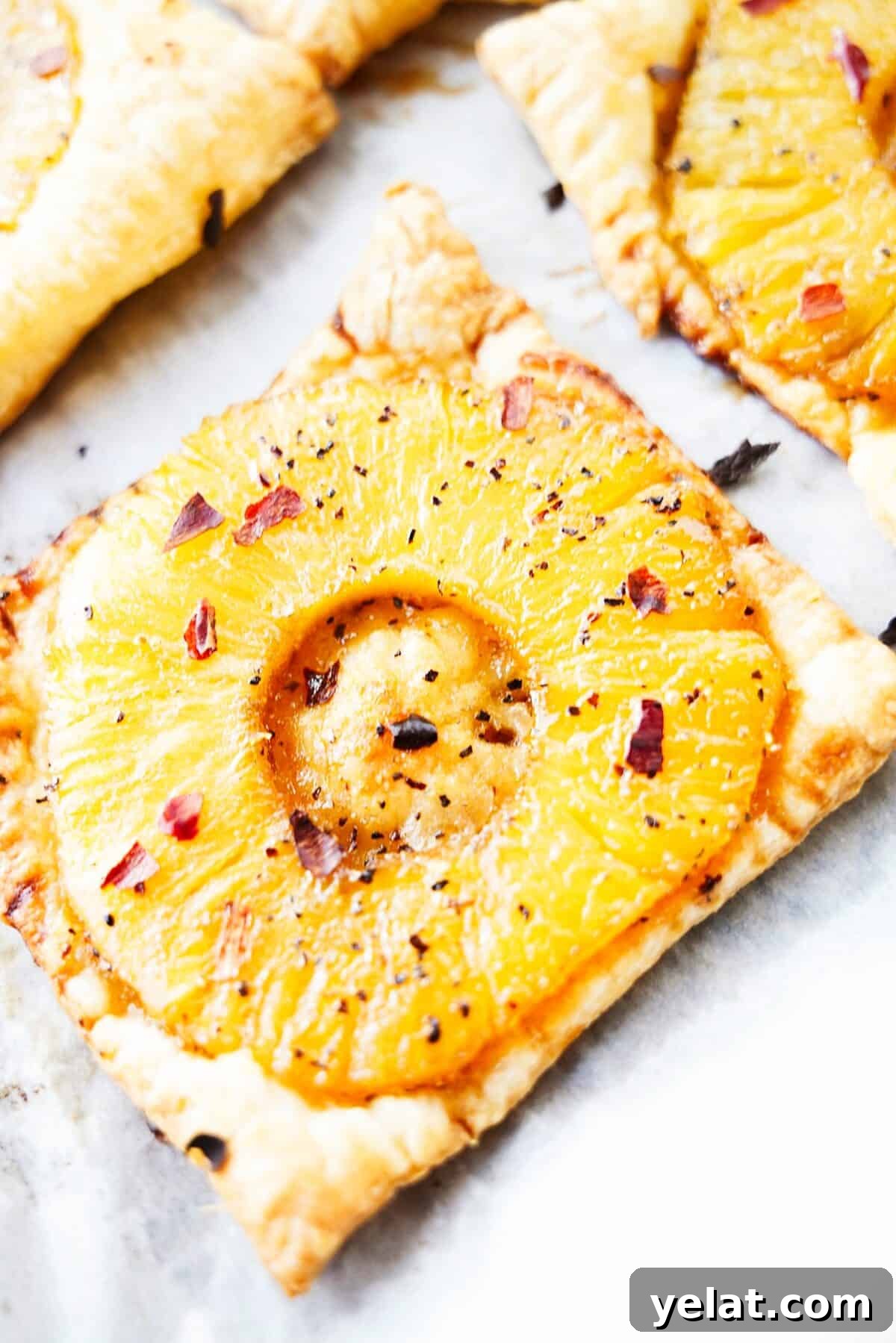 Spicy Pineapple Tart Recipe: Sweet and Tangy Baked Cookies 10 close up vertical shot of spicy pineapple tart topped with crushed red pepper flakes