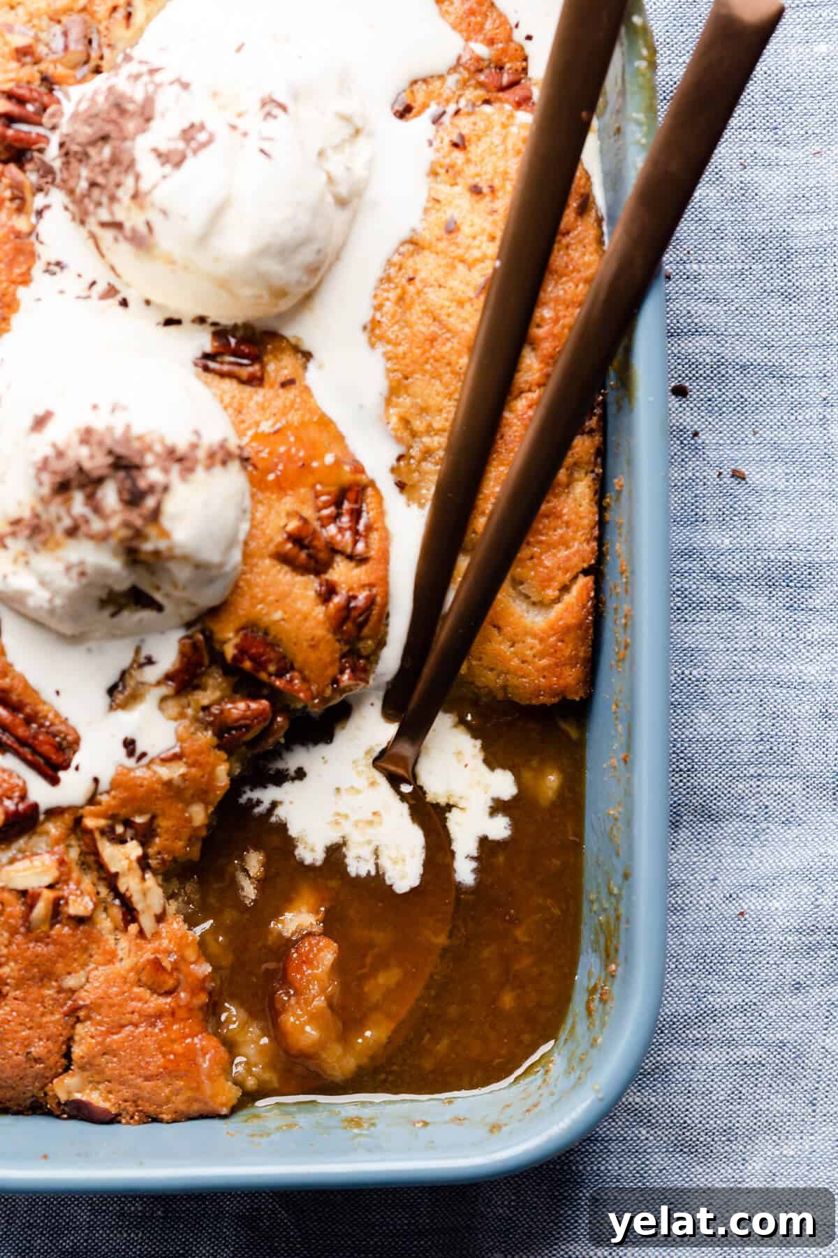 Self-Saucing Banana Pudding Recipe with Gooey Caramel Sauce 11 top view super close up at baking dish with self saucing banana pudding with a portion of it missing