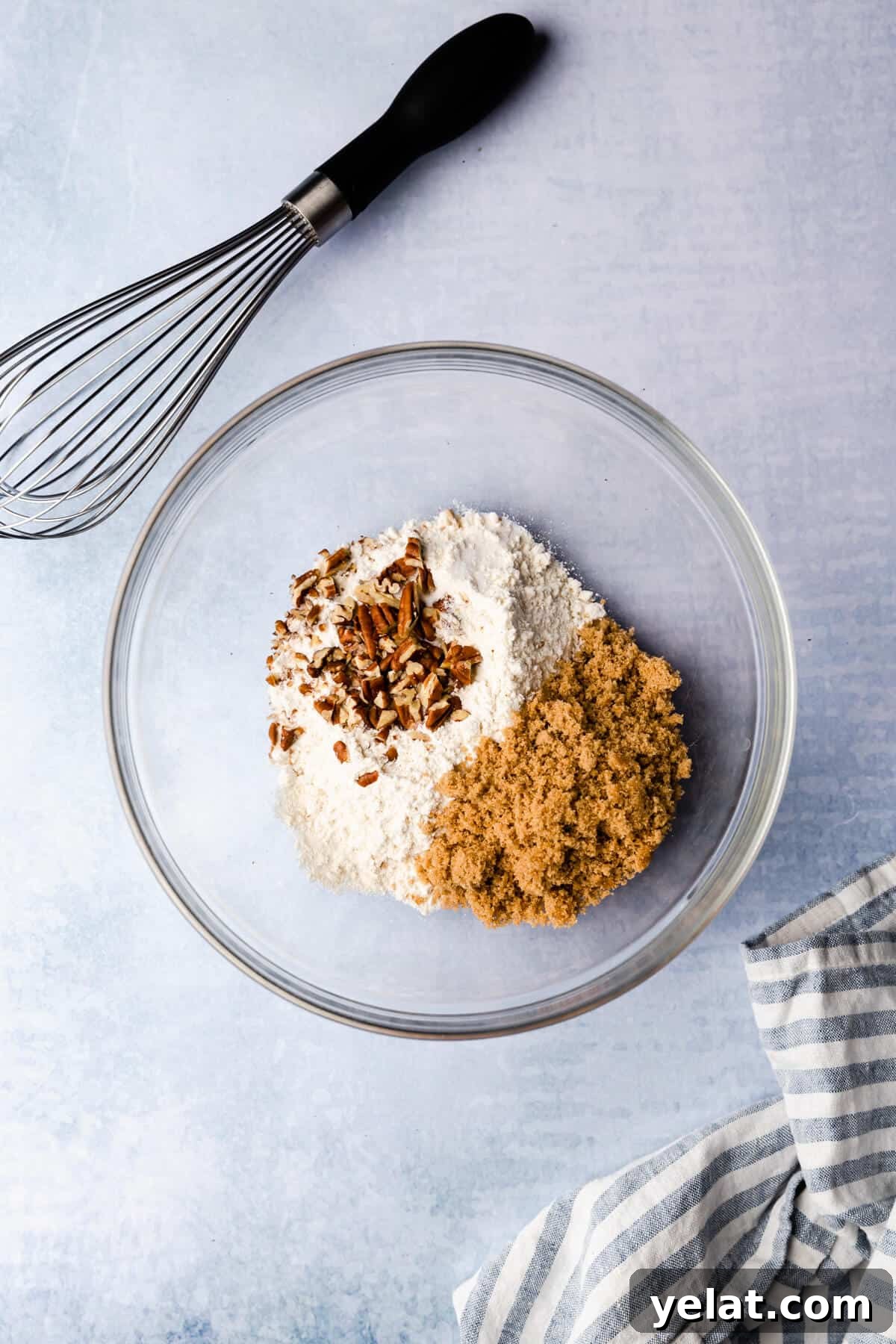 Self-Saucing Banana Pudding Recipe with Gooey Caramel Sauce 4 top view of the mixing bowl with some dry ingredients and whisk on side
