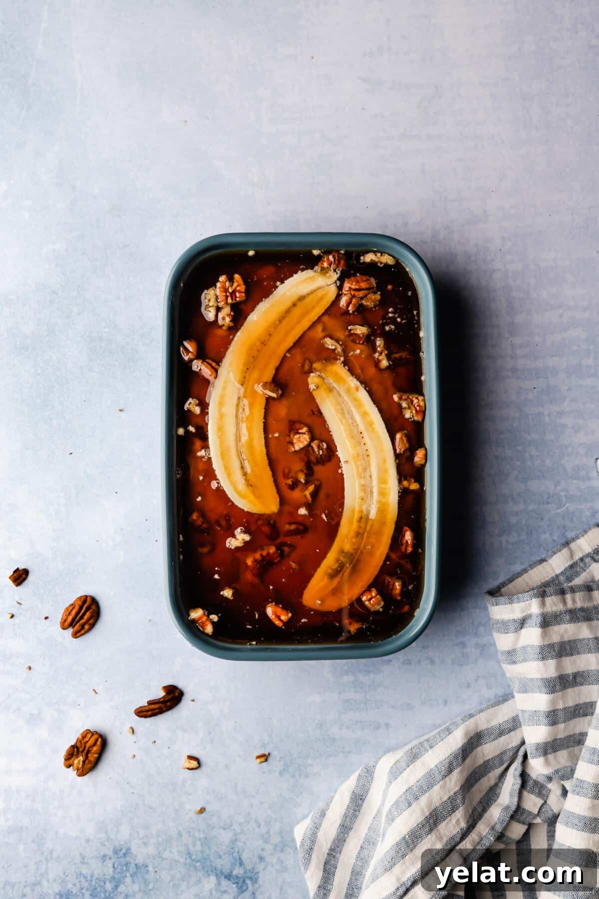 Self-Saucing Banana Pudding Recipe with Gooey Caramel Sauce 8 overhead shot of baking dish with self saucing banana pudding batter covered in liquid