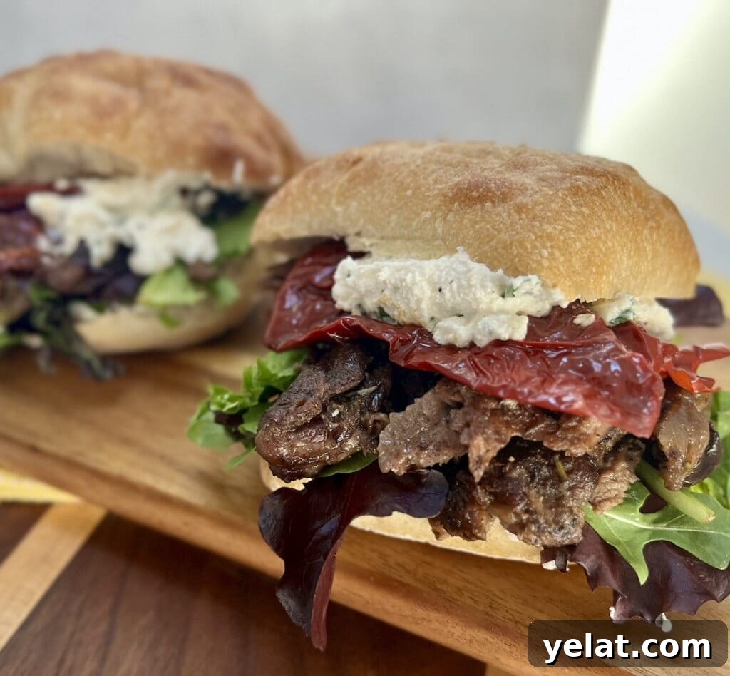 Slow-Roasted Mediterranean Lamb Shoulder Recipe 18 Slow Roasted Lamb Shoulder sandwiches with herbed ricotta, sun dried peppers and mixed greens on cutting board.