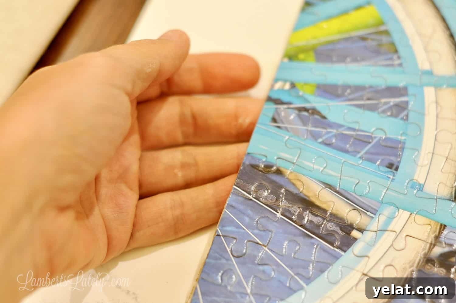 How to Glue and Hang a Puzzle Without a Frame 8 removing a preserved puzzle from poster board.
