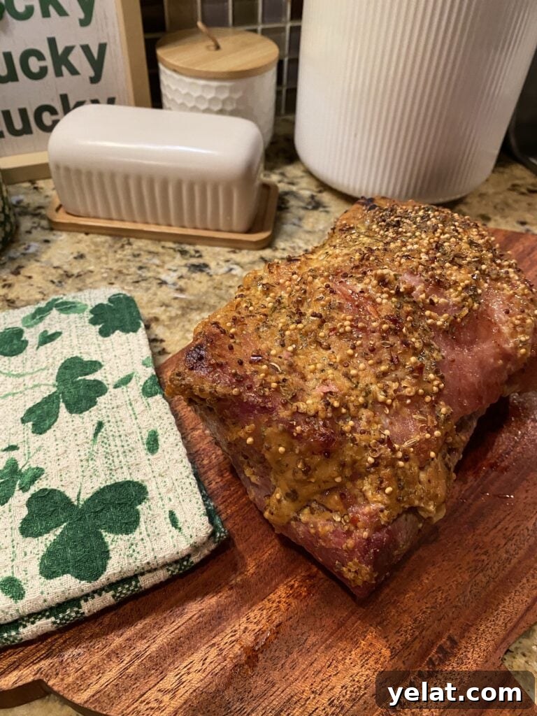 Oven baked corned beef on a cutting board before being sliced