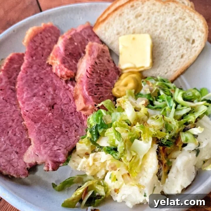 Slices of corned beef on a plate with potatoes and bread