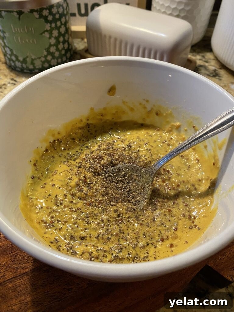 The mustard glaze being stirred in a bowl
