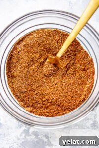 15 Homemade Seasoning Recipes to Transform Your Cooking 12 chili seasoning in a glass bowl with a wooden spoon inside